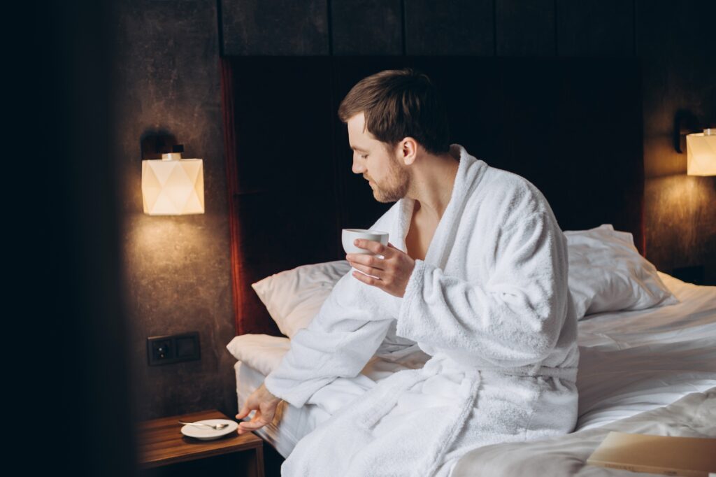 A businessman rests in a hotel room after a flight.